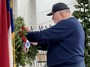 Commander Ed McCloskey places the Marine wreath.
